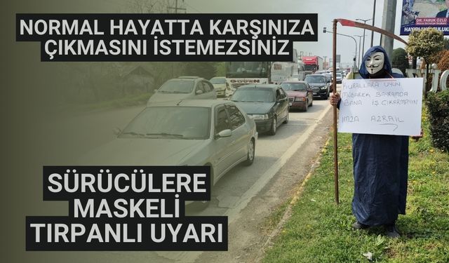 Sürücülere maskeli, tırpanlı uyarı