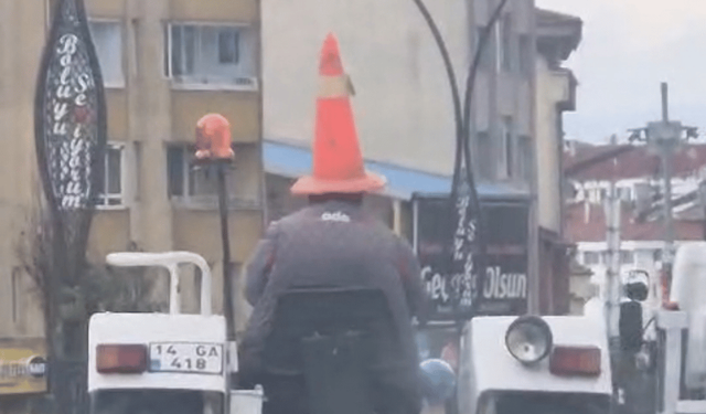 Bolu'da trafikte ilginç görüntü: Başına duba geçirip traktör sürdü