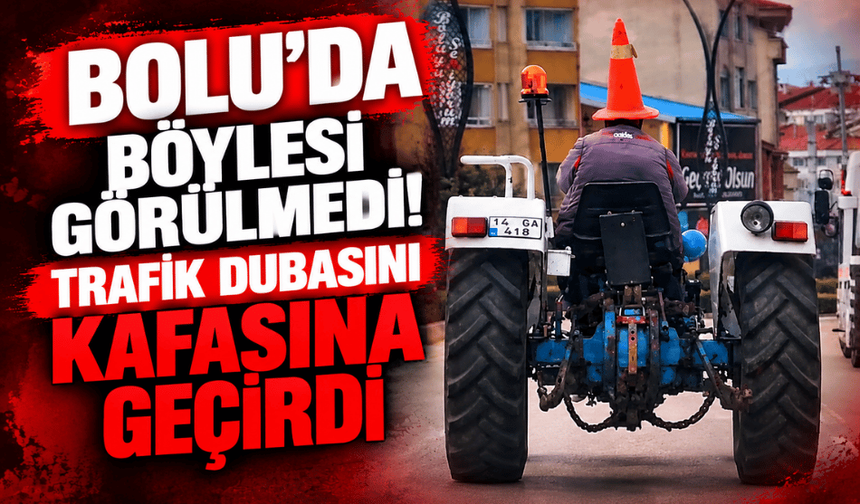 Bolu'da trafikte ilginç görüntü: Başına duba geçirip traktör sürdü